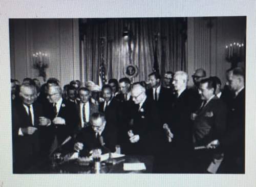 This picture shows lyndon b. johnson signing the civil rights act in 1964. this law was especially i