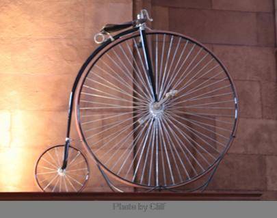 Look at the image of the high wheeler. Read the excerpt from Chapter 1 of Wheels of Change. Pope was