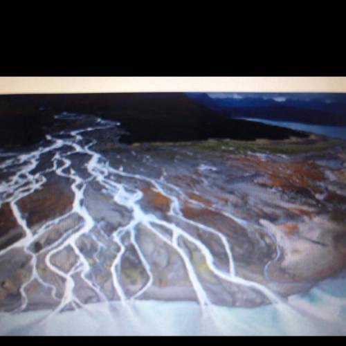 What body of water is shown in this photo and how does erosion help create it