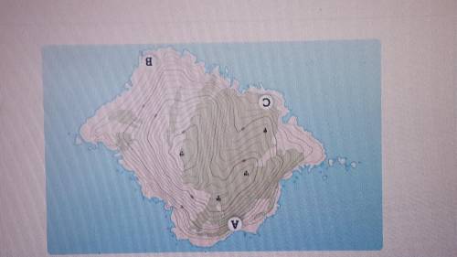 What kind of land feature is shown at point C on the topographic map?

A. A step slope
B. A lake
C