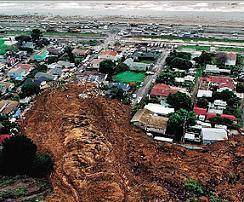 What event caused the changes in the Earth's surface and destruction of homes in the pictures below