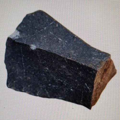 The rock shown here is basalt. It has small crystals and a fine-grained texture.

This sample was