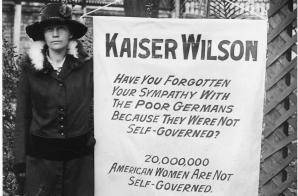 What cause does this woman support?
How is the banner critical of Woodrow Wilson?